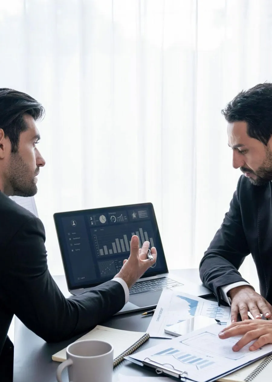 Financial professionals reviewing dashboards and reports together